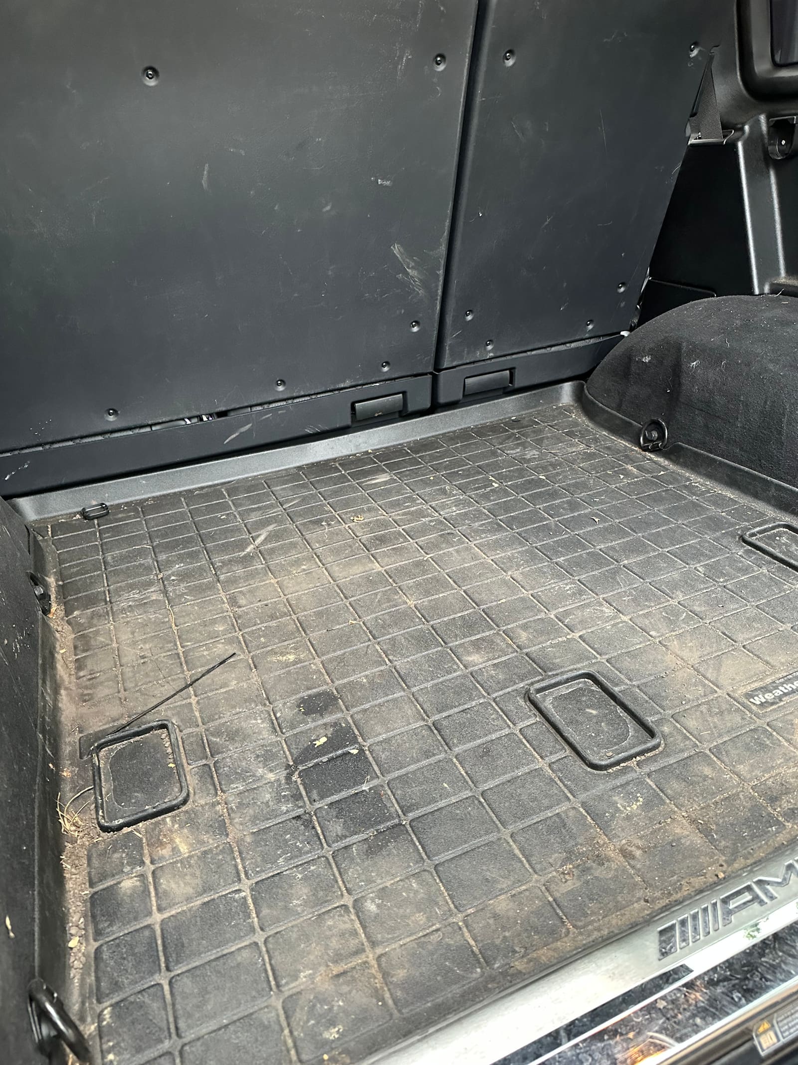 Wide view of cargo area before detailing, dusty with debris